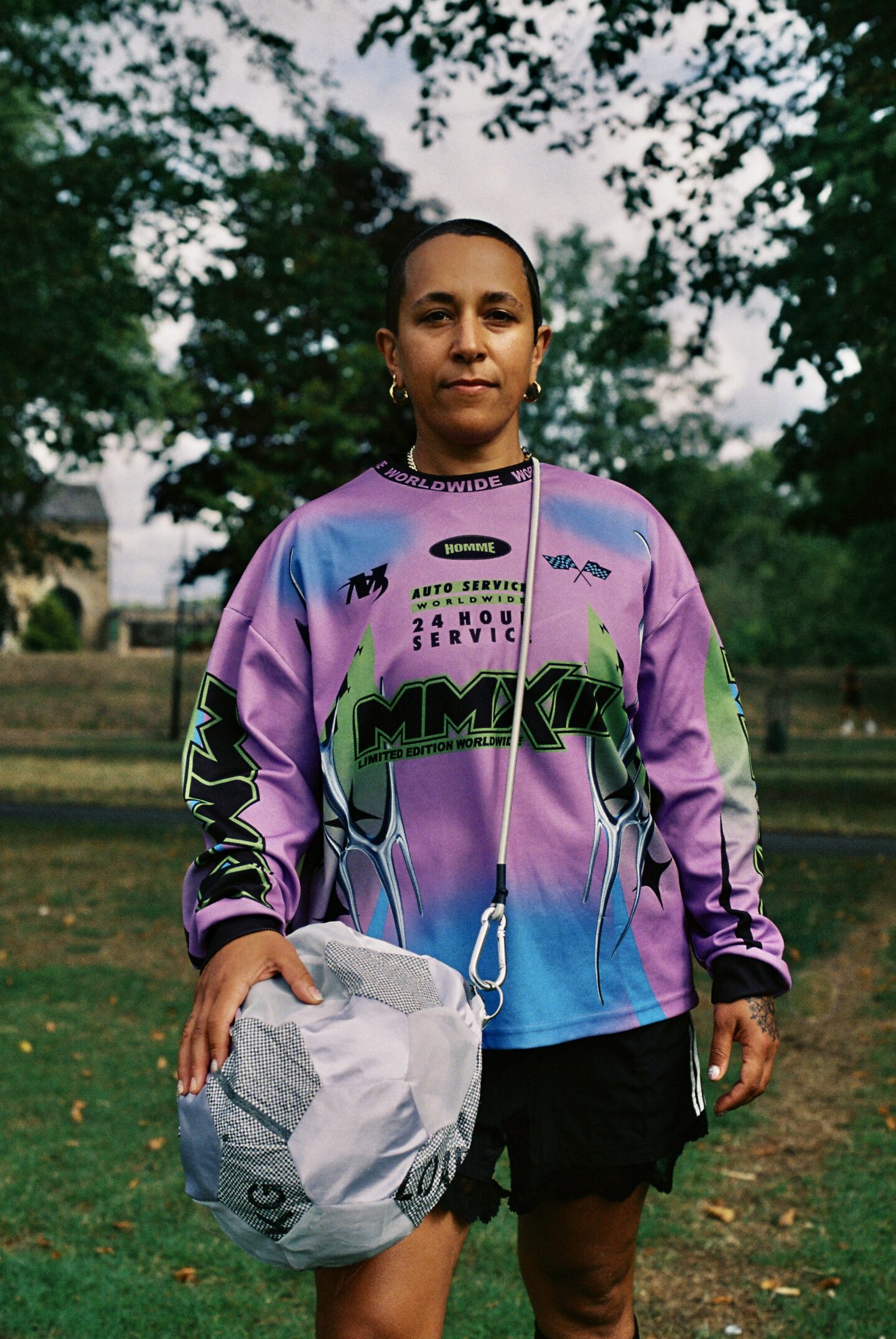 A person with purple football t-shirt on and a football bag