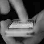 Person messaging on their phone, black and white