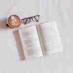 book near eyeglasses and cappuccino