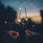 person holding fire cracker shallow focus photography