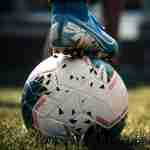 lesbian footballers -white and blue soccer ball on green grass field