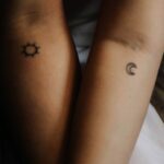 two persons showing their hand tattoos