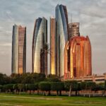 green grass field near high rise buildings during daytime