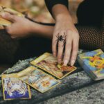woman holding tarot cards