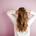 The 6 Best Scalp Massagers to Promote Hair Growth. Woman running fingers through hair