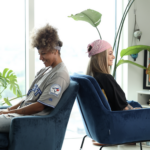 Meg and Lailah sit back to back