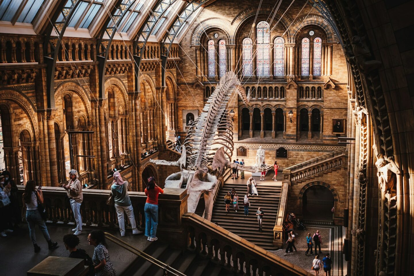 a large room with people and stairs