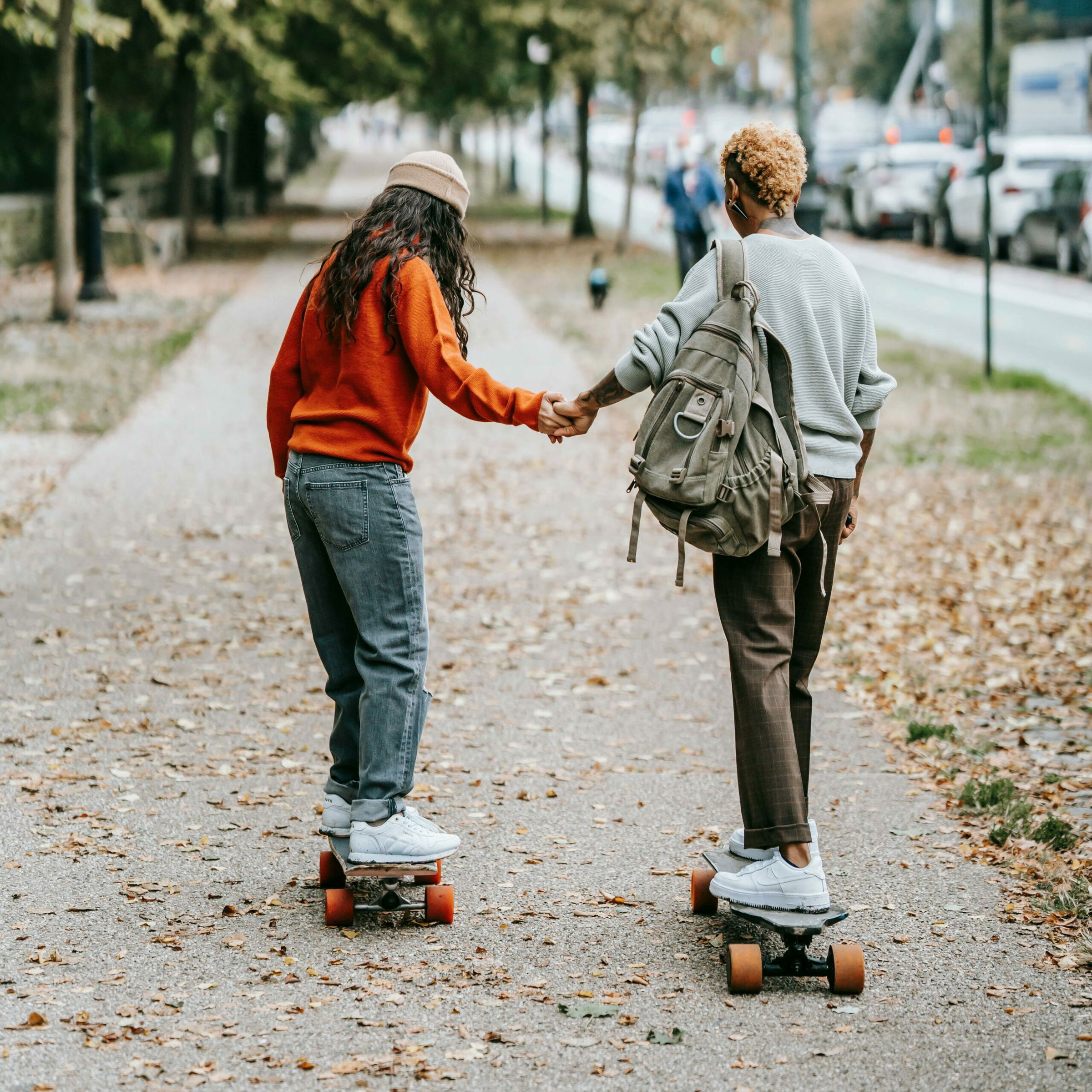 women in a park on skateboards