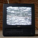 black crt tv on brown wooden table