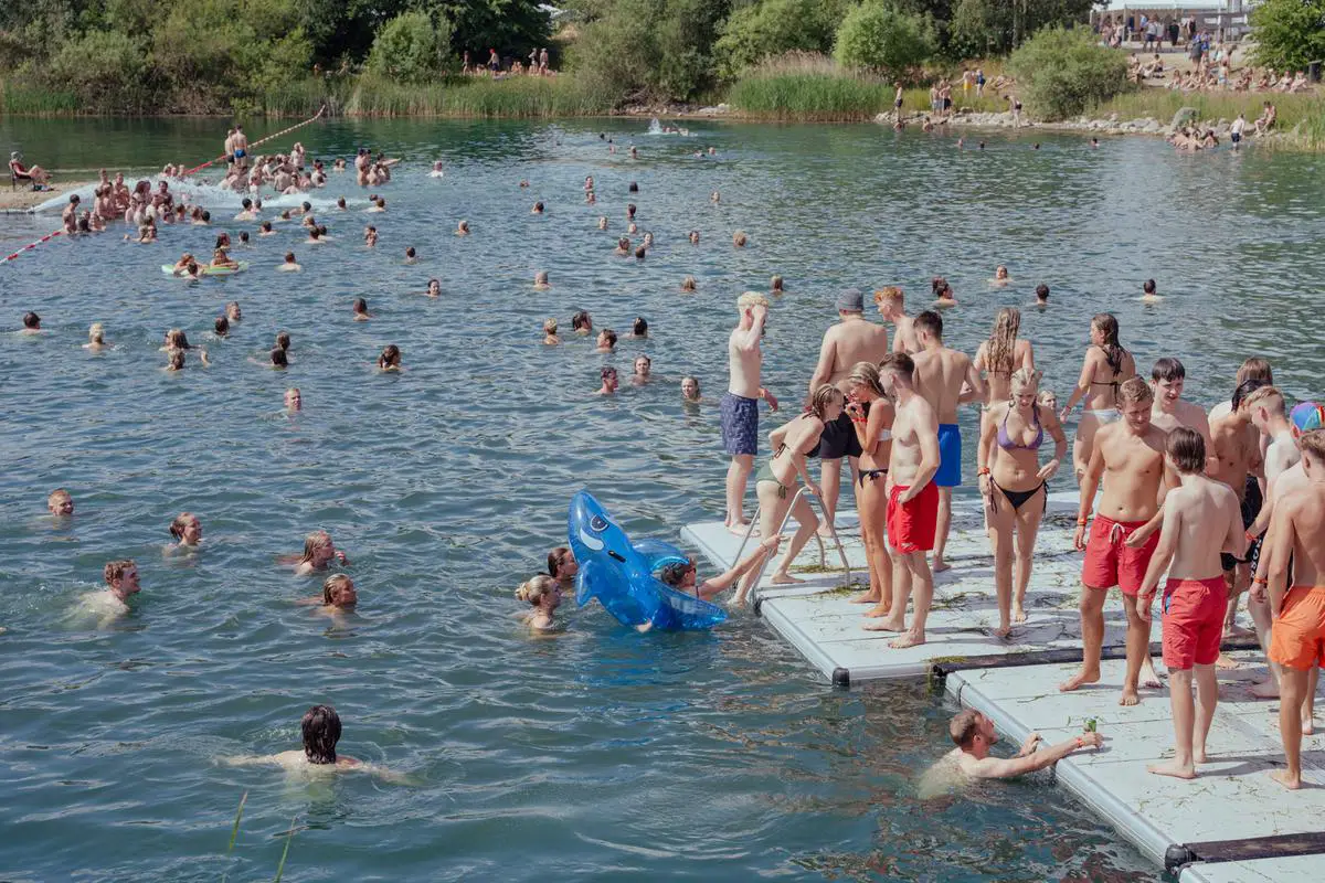 Volunteers swimming in a lake in Volunteers Village Roskilde Festival