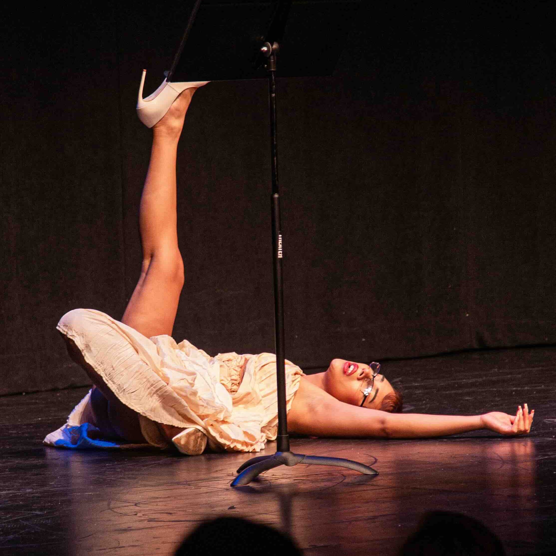 a girl laying on the floor in a dress