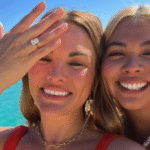 Hayley Kiyoko and Becca Tilley smiling with an engagement ring