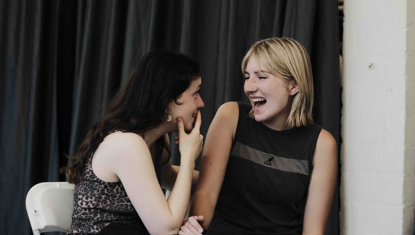 Two women smiling at each other