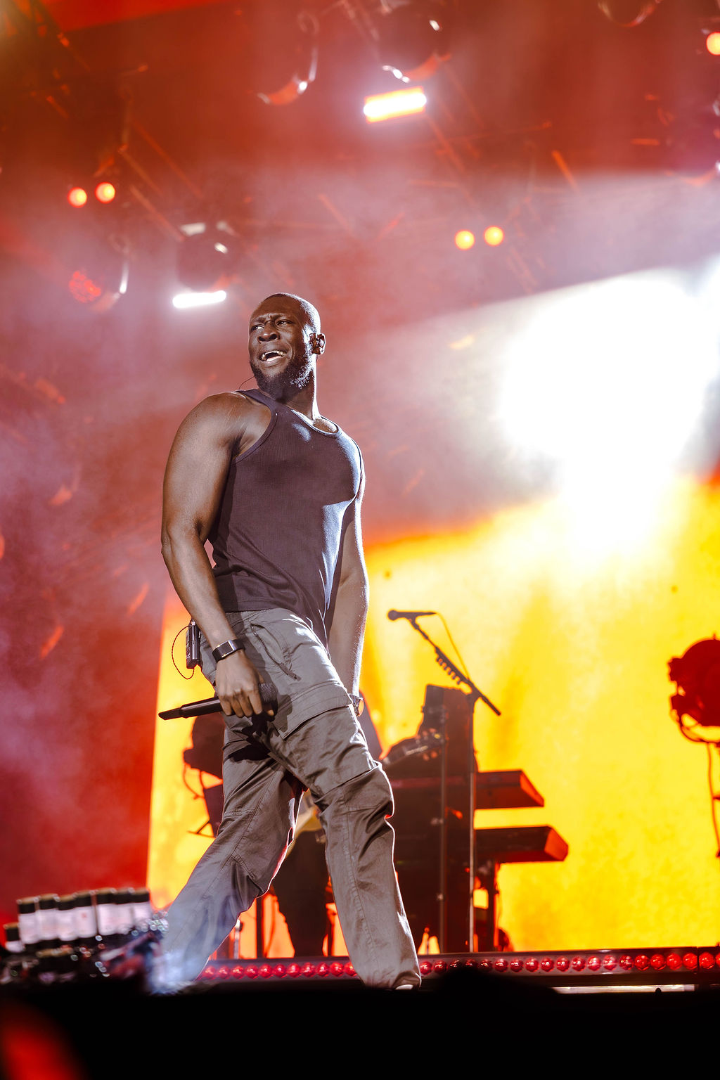 Stormzy on stage with red lights in the backgrouns