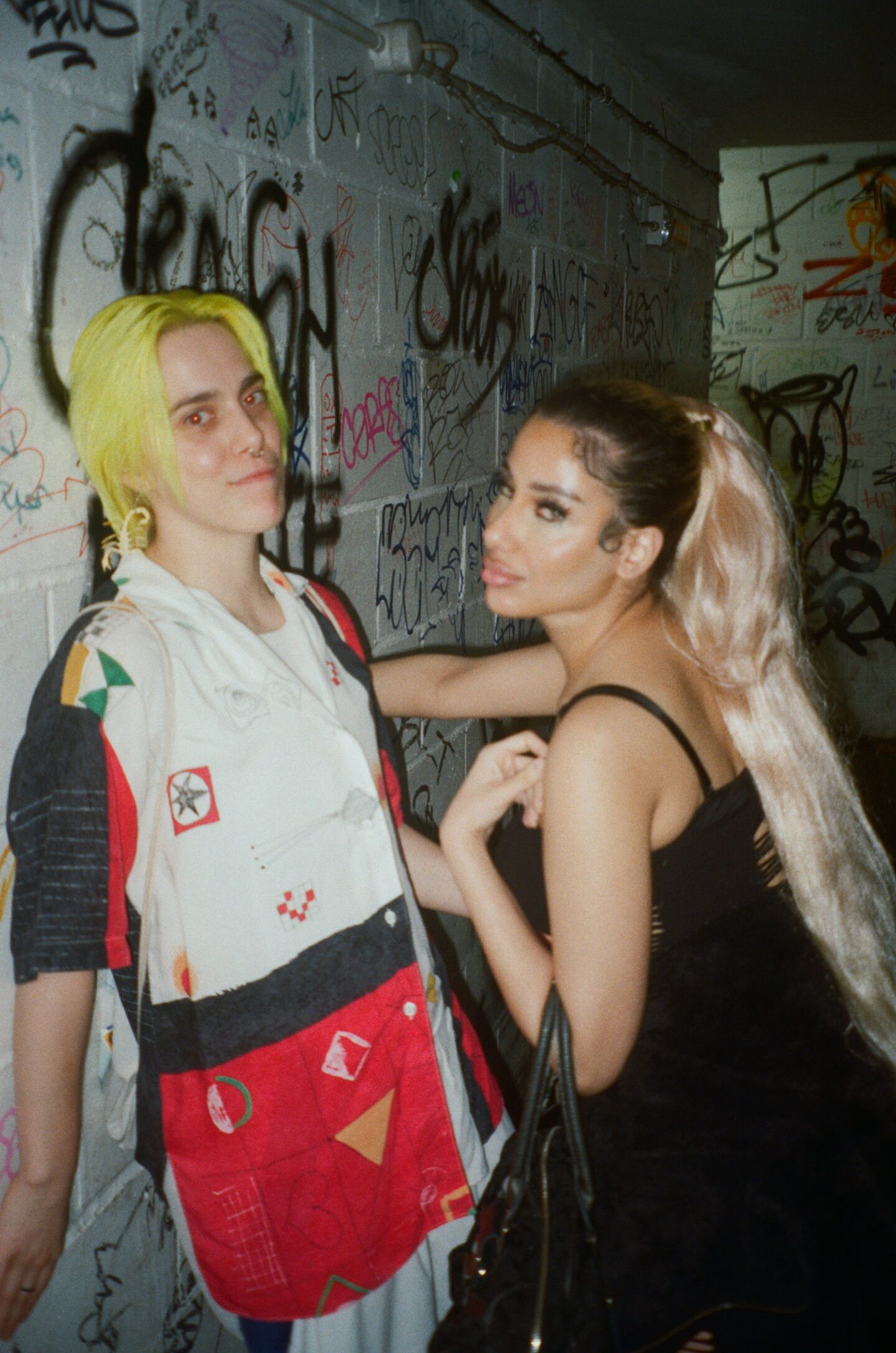 two people, one is up against a wall