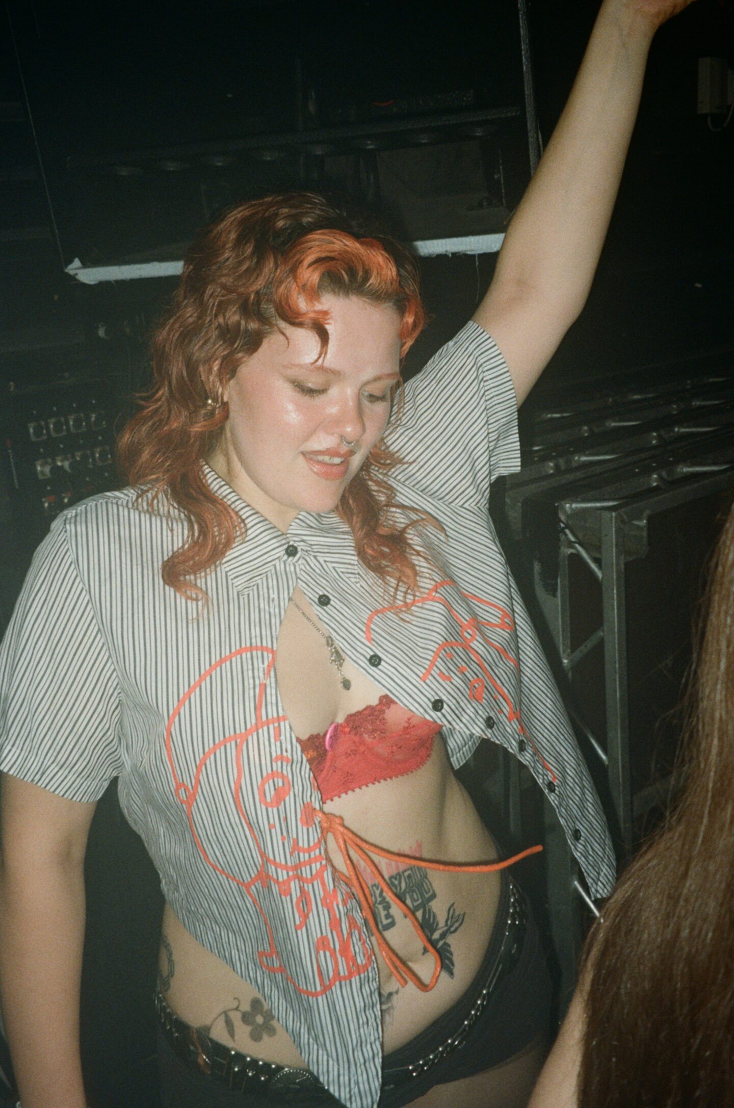a person with red hair and a shirt on dancing