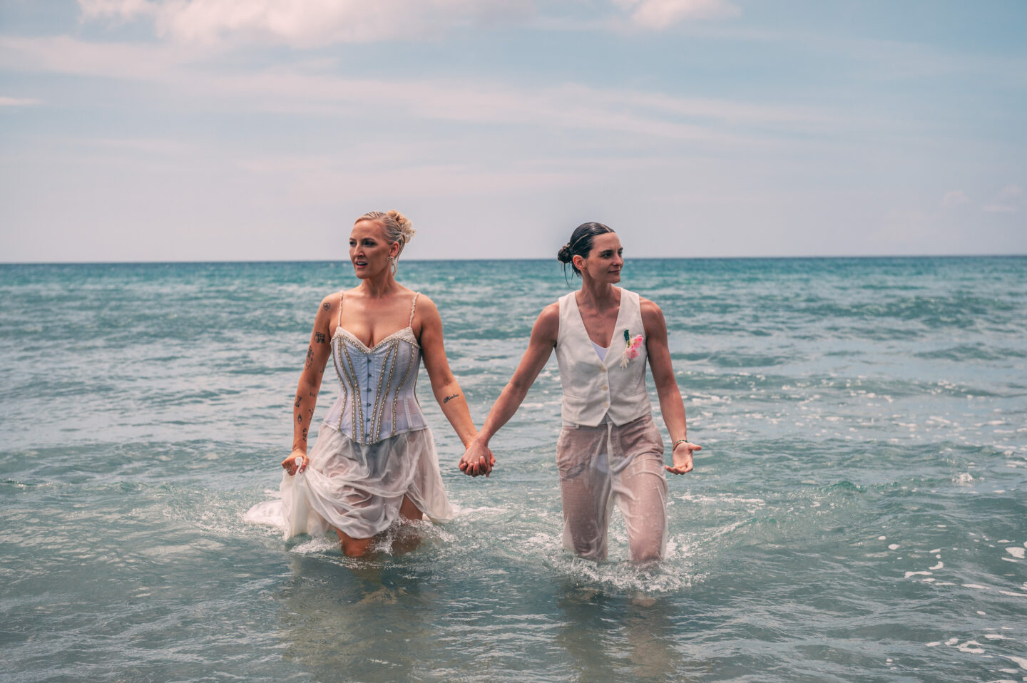 Honeymoon Island Helen Scott and Abby Reynolds walking out of the sea in wedding outfits