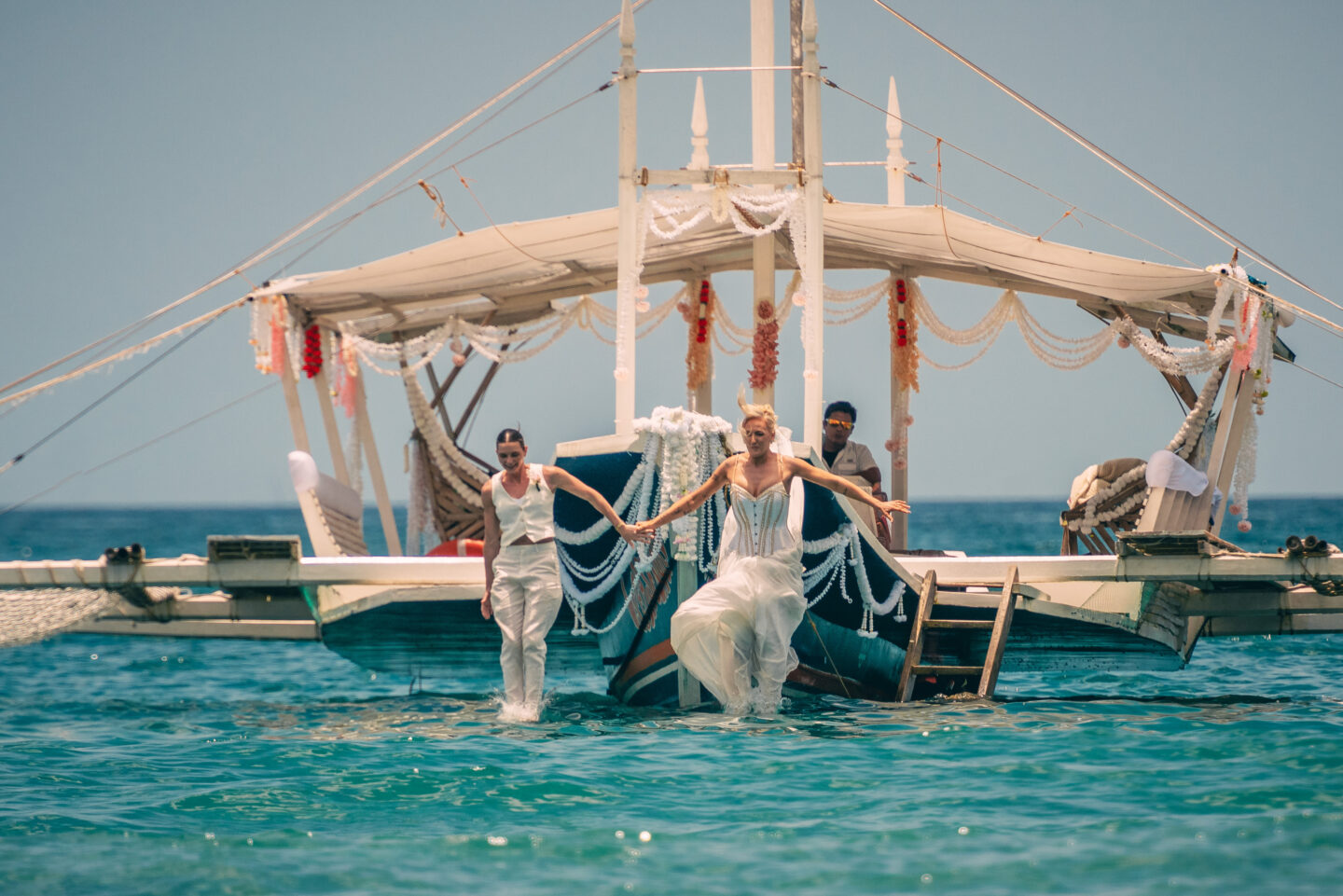 Abby Reynolds and Helen Scott jumping in to the sea from a boat on Honeymoon Island