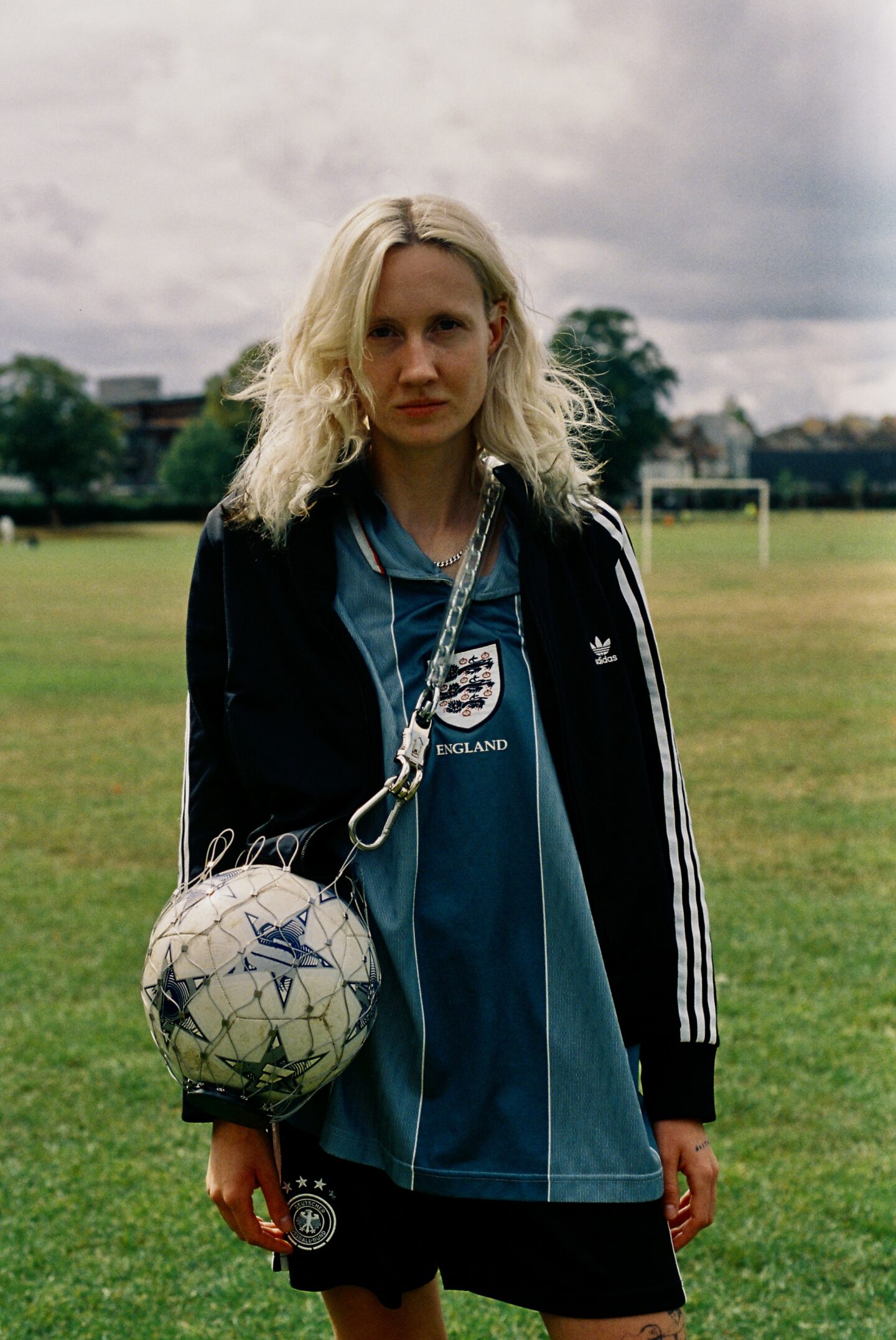 Lezbag x Ex-Girlfriend FC - person with an england football top on holding one of the bags