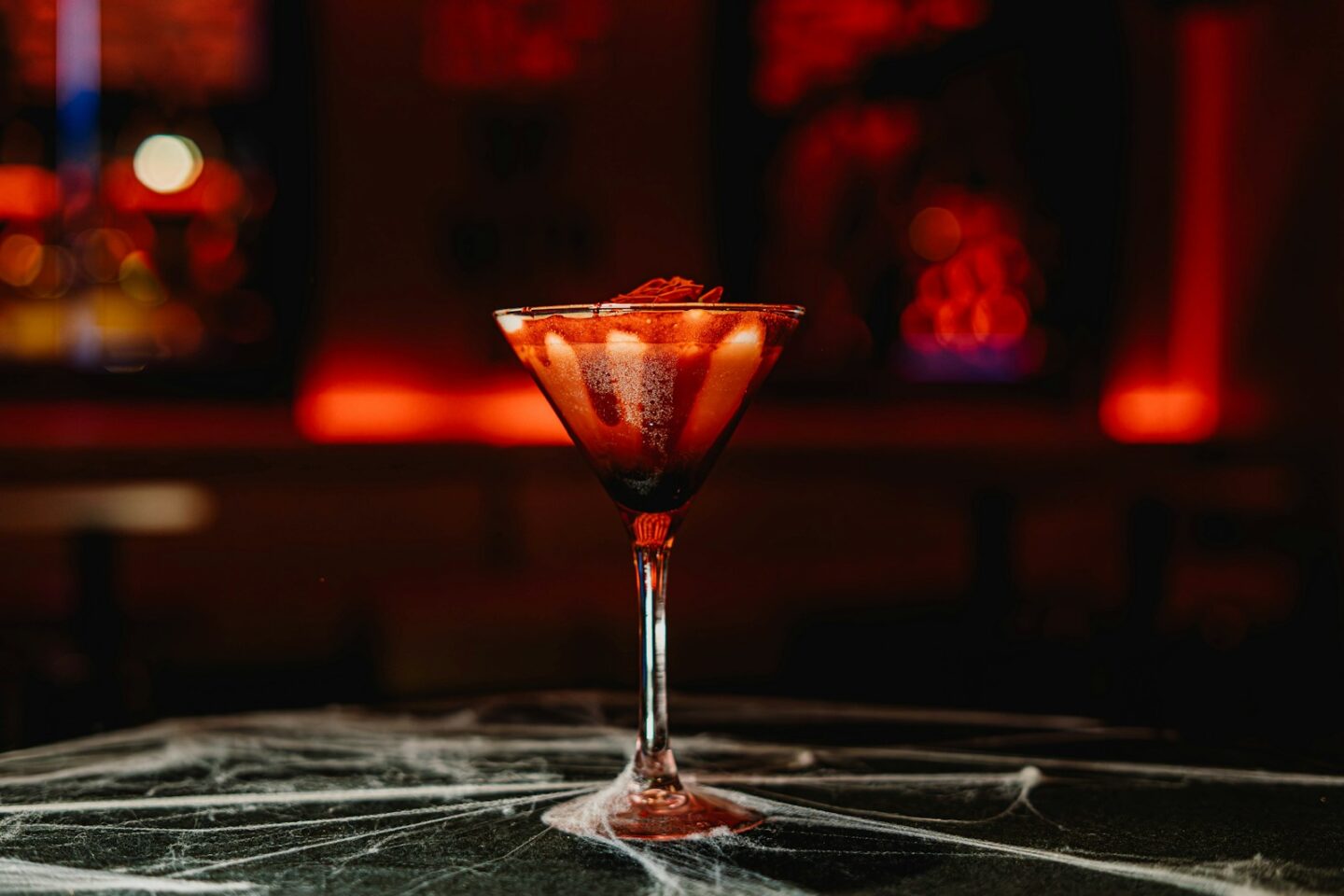 Bloody cocktail with cobwebs and red lighting - Blood Kiss Martini