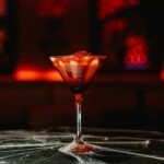 Bloody cocktail with cobwebs and red lighting