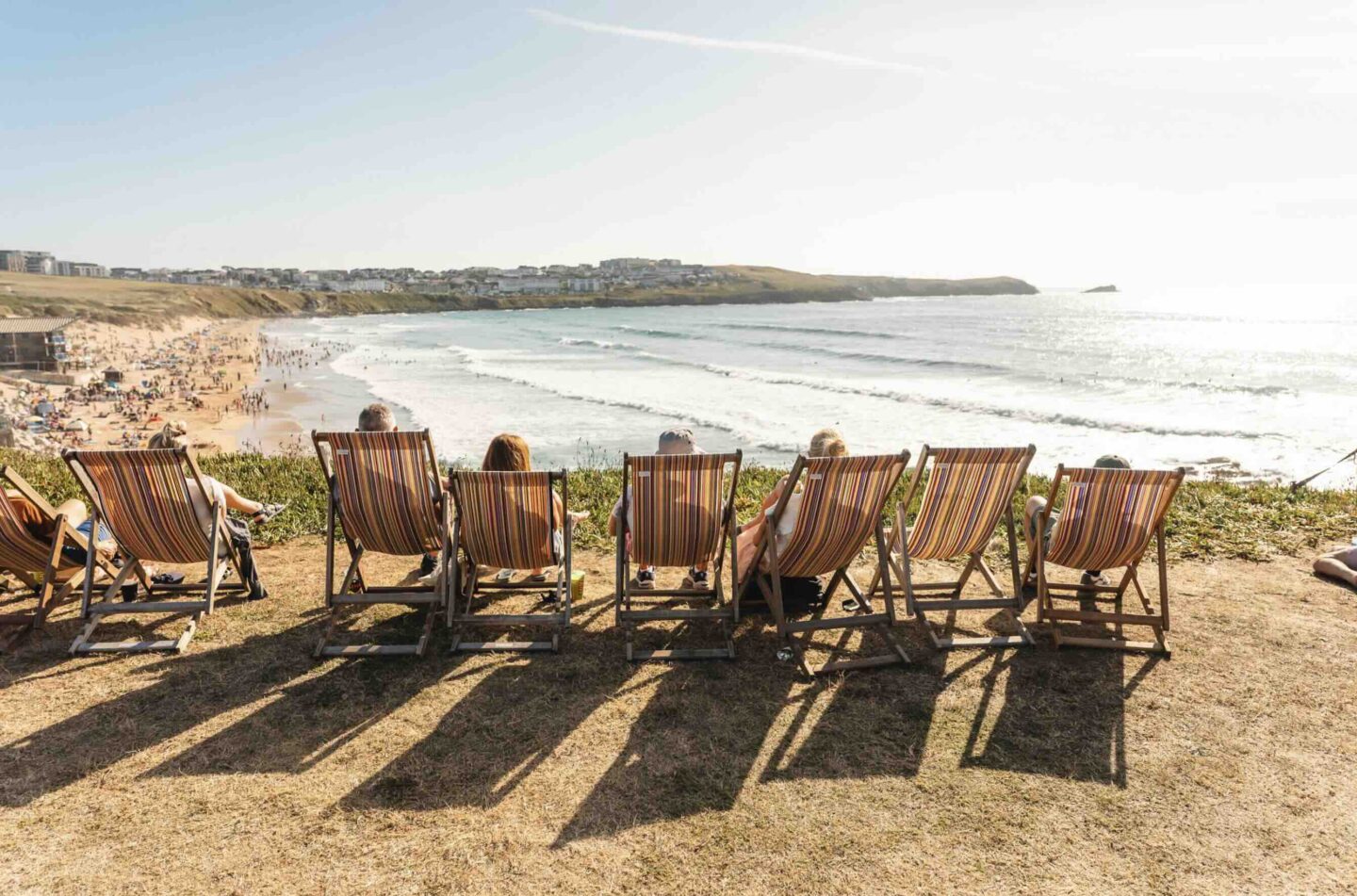 people sitting on deck chairs