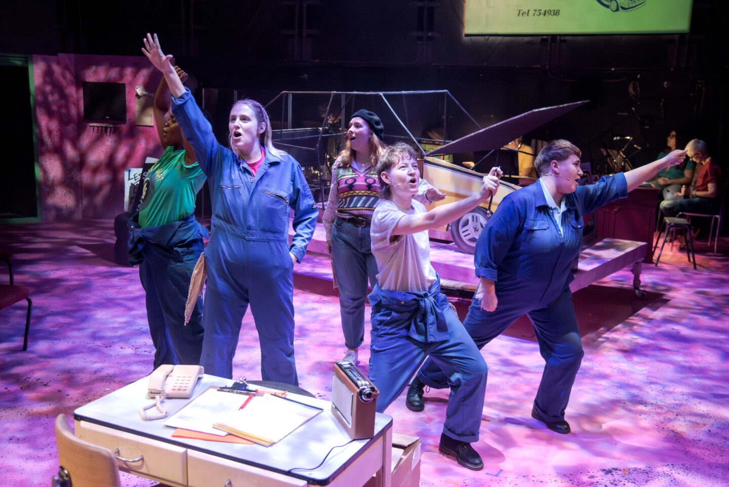 Gwenda’s Garage. People singing on a stage.