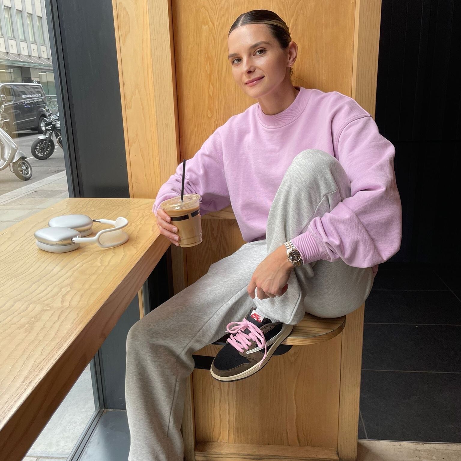 Abby Reynolds from Stranded on Honeymoon Island in a pink jumper with a coffee