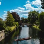 a man is rowing a boat down a river