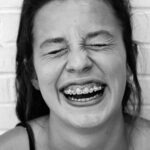 smiling woman in black tank top