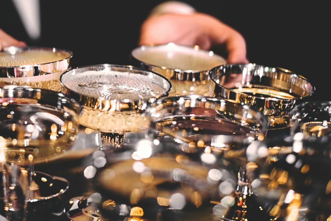 person standing beside martini glasses