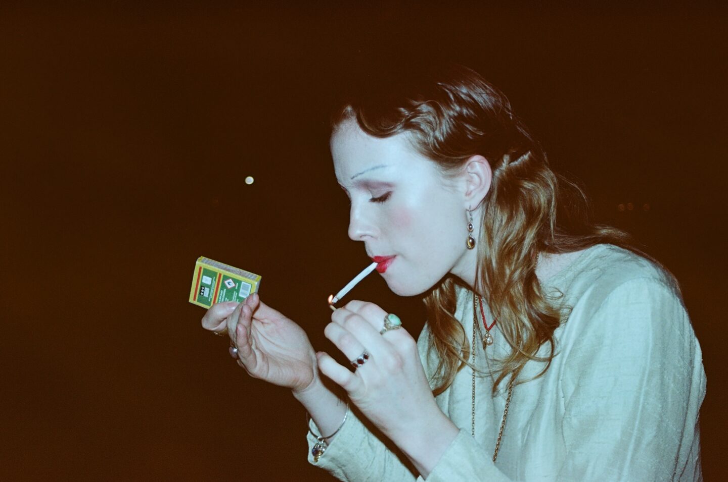 A person lighting a cigarette