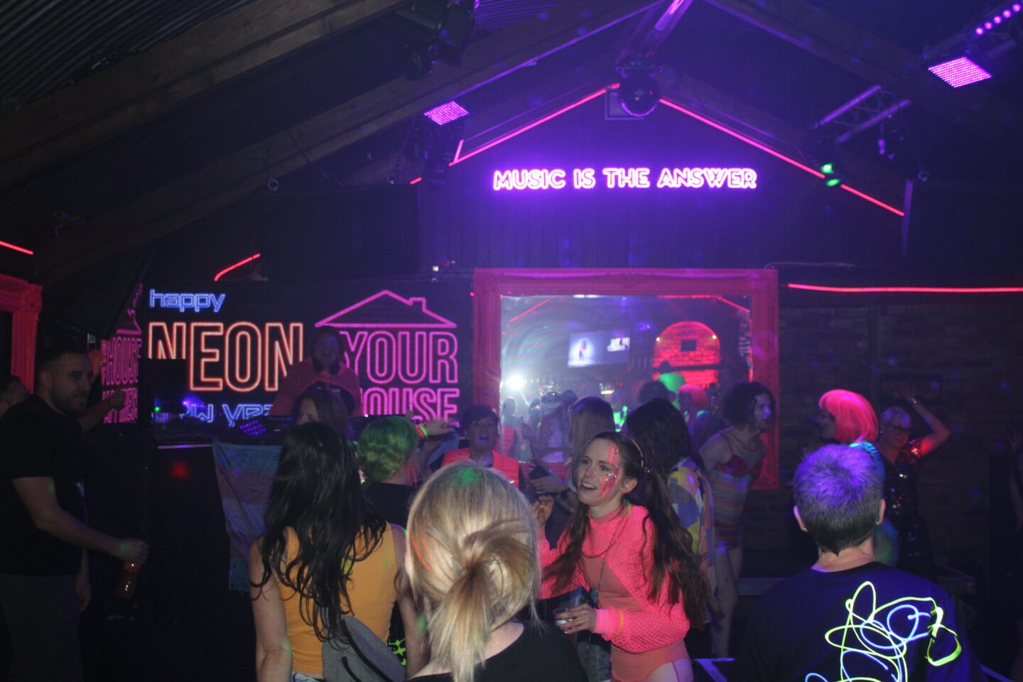 People at a rave with neon lights