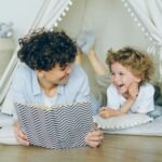 a woman reading a book to a child