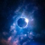 a black hole in the sky with stars