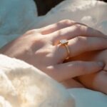 a close up of a person's hand with a ring on it