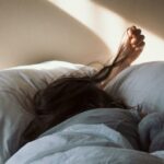 woman lying on bed