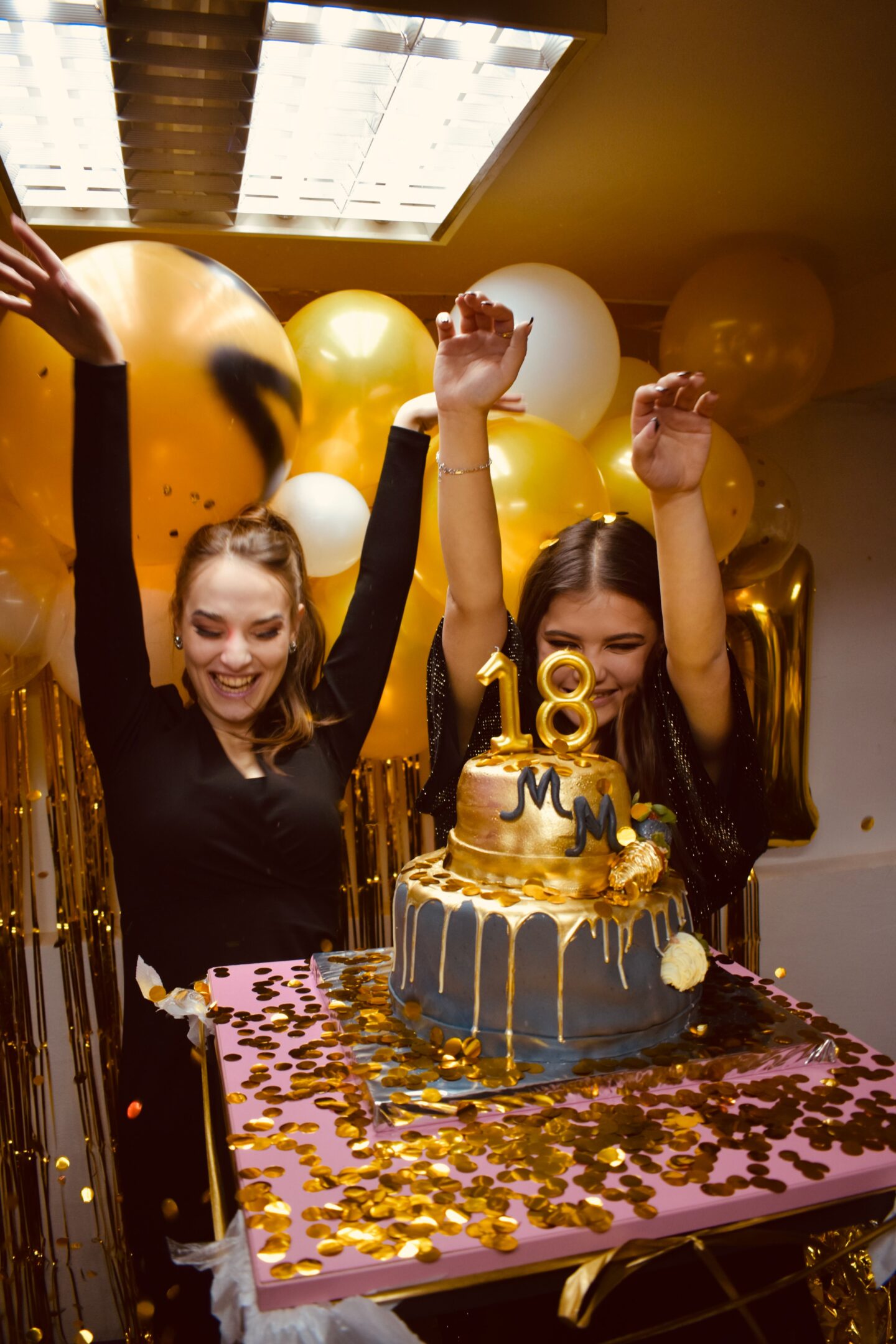 18 birthday cake and two women celebrating