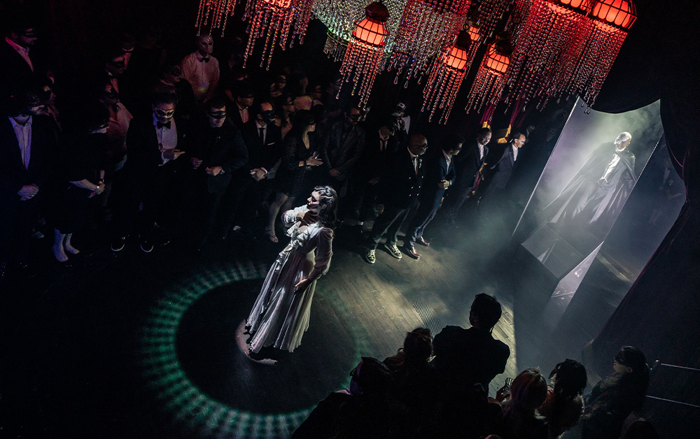 Aerial view production photo of the character Christine in Masquerade